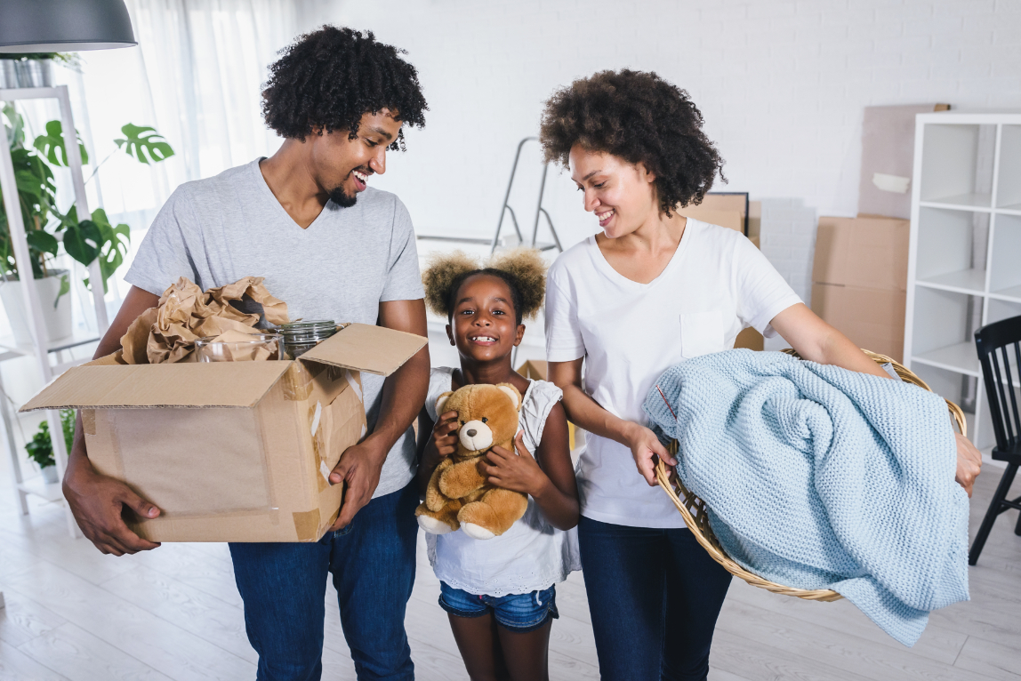 Happy playful African American family moving in new apartment, unpacking, moving stuff, purchase property concept